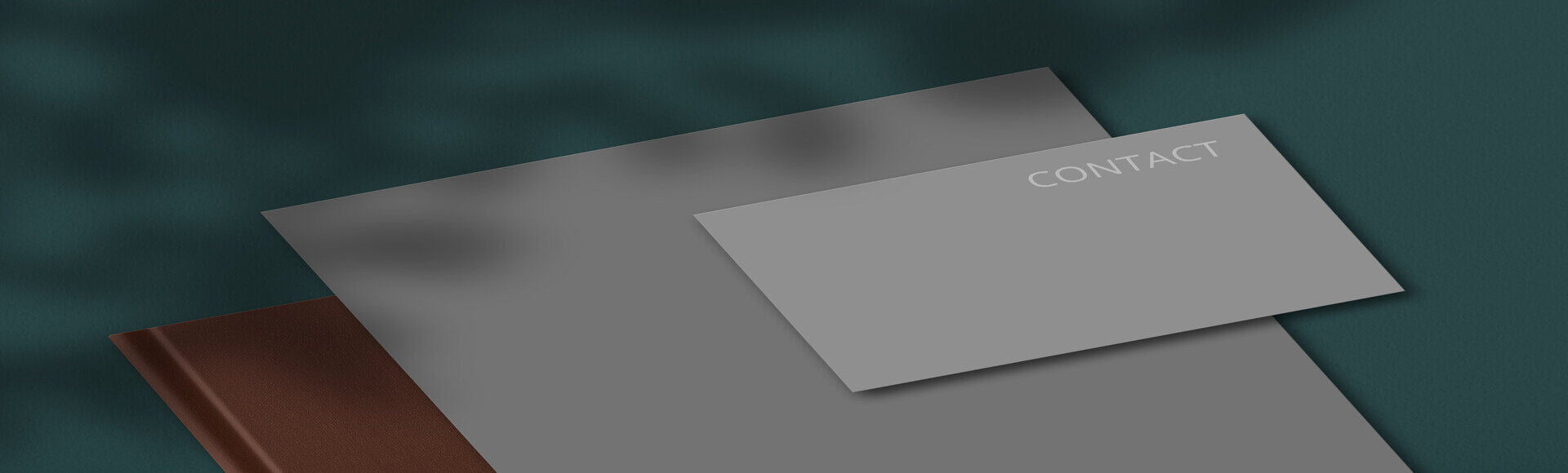 Set of stationery with empty blank grey notepad and business card for your contact or information against dark green background.